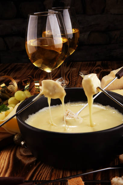 istock Gourmet Swiss fondue dinner on a winter evening with assorted cheese 1063878992