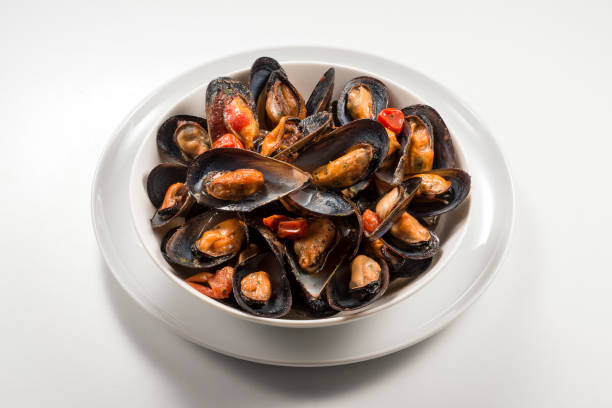 istock Bowl with cooked and open mussels 1063879054