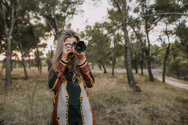 istock Young woman usign a DSLR camera 1063879066