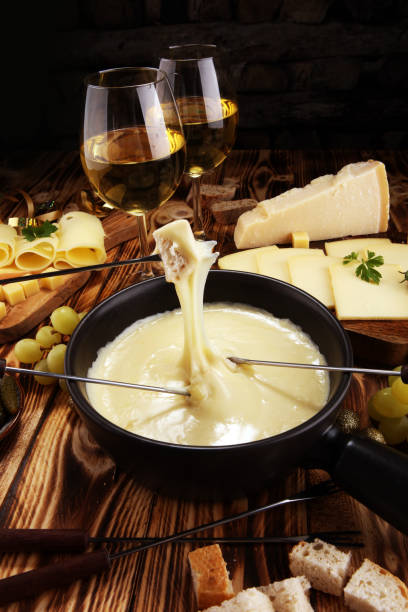 istock Gourmet Swiss fondue dinner on a winter evening with assorted cheese 1063879114