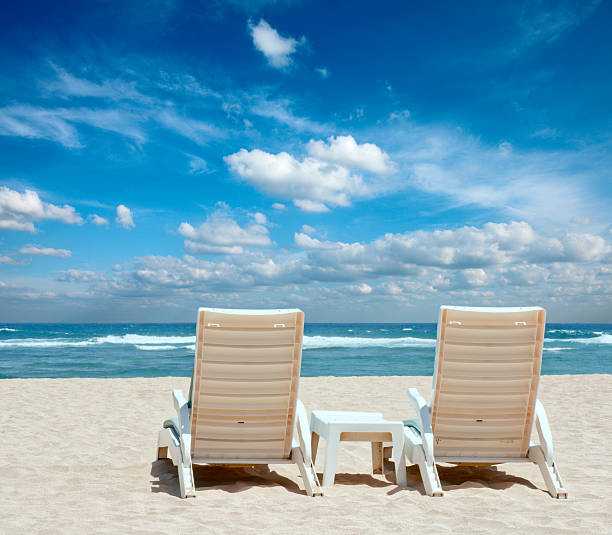 istock Two sun beach chairs on shore near ocean 106387981