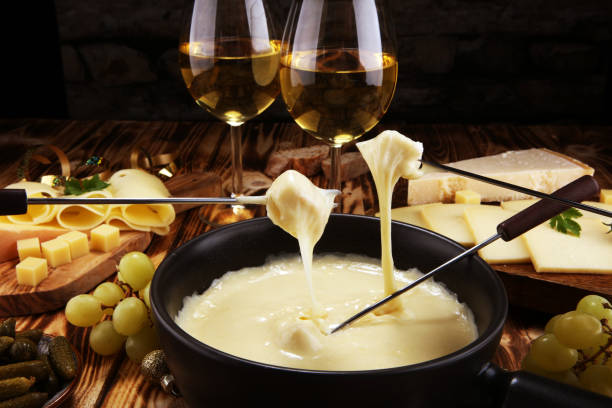 istock Gourmet Swiss fondue dinner on a winter evening with assorted cheese 1063880482