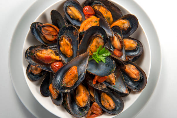 istock Top view of Bowl with cooked and open mussels 1063881524