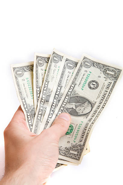 istock dollars in a hand isolated on white 106388619