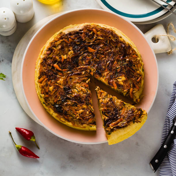 istock savory salty  Upside-Down pie from white cabbage, carrots and onions. gluten free no eggs , with chickpea flour. family breakfast or party snack on a white marble table 1063886956