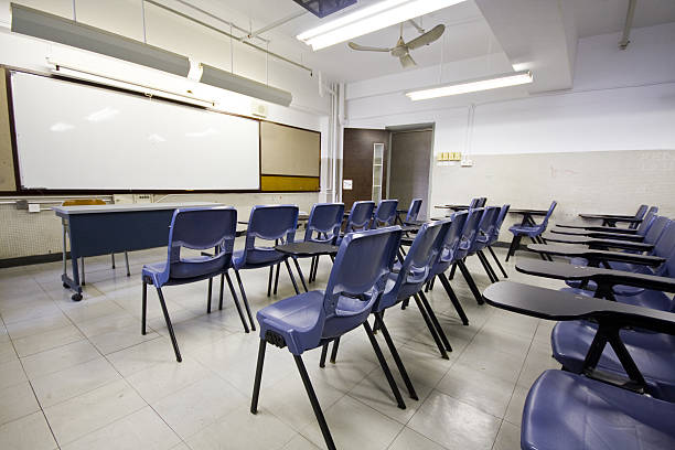 Empty classroom with blue chairs and white board stock photo