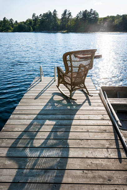 istock Rocking chair on small lake dock 1063890598