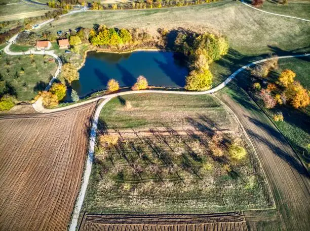 Little lake, fruit trees and hiking trail at Nuremberg countryside. Autumn.