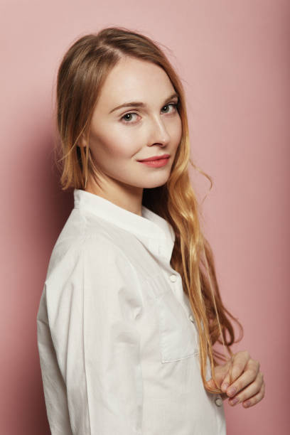 istock Pretty young woman posing on pink background 1063895152