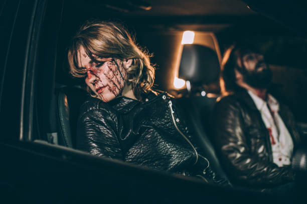 Couple in a car accident Man and woman victims of car accident sitting in the car with blood on their head couple driving at night stock pictures, royalty-free photos & images
