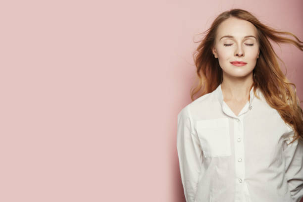 istock Pretty young woman posing on pink background 1063897020