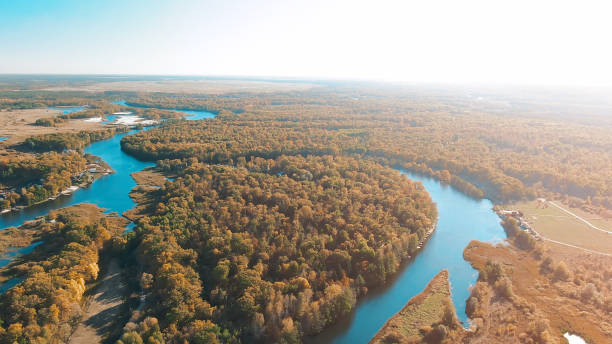 istock Cinematic aerial view, flight over a beautiful meandering river, panoramic view from a great height 1063897502