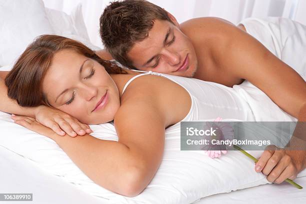 White Bedroom Young Couple Lying Down In Bed On Honeymoon Stock Photo - Download Image Now