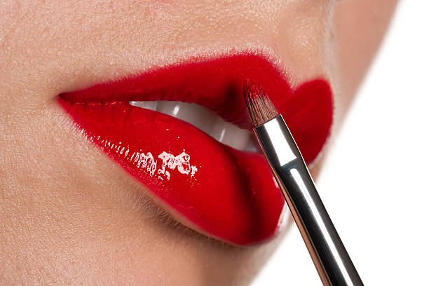 istock Woman applying glossy red lipstick on white background 106390176