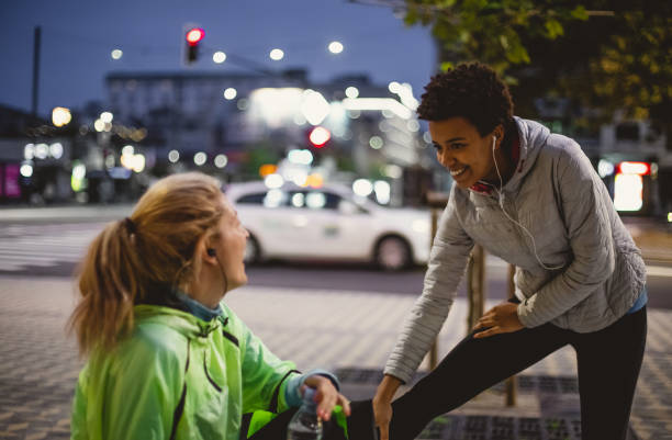 istock Two Female Athletes Preparing Themselves For Street Running 1063902850