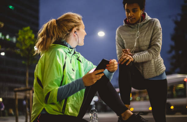 istock Two Female Athletes Preparing Themselves For Street Running 1063903020