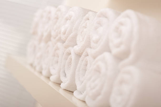 istock Line of rolled up white bath terry cloth towels 106390451
