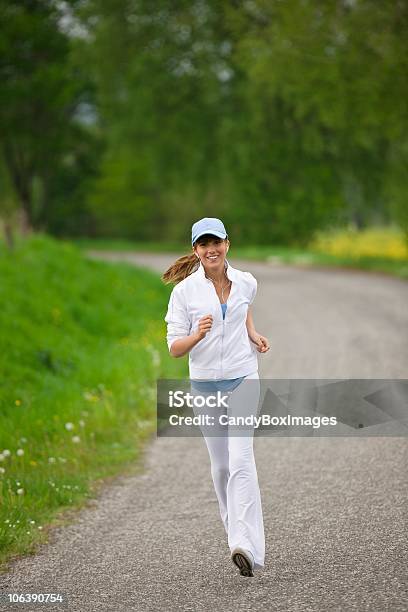 Jogging Sportive Woman Running On Road In Nature Stock Photo - Download Image Now - Adult, Adults Only, Athleticism