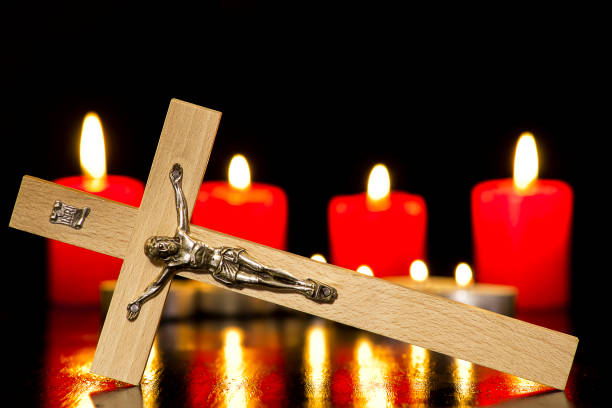 istock A crucifix against a background of lighted candles 1063908872