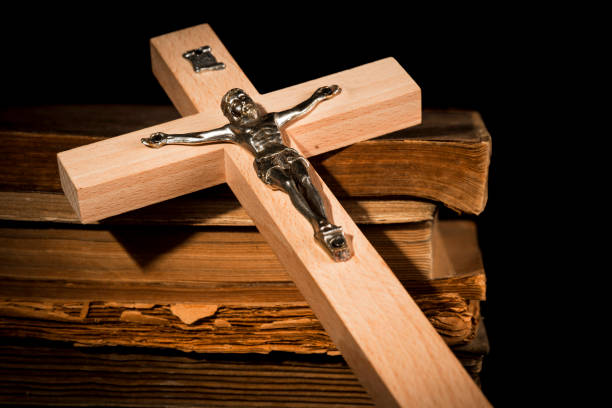 istock Crucifix against the background of books 1063909090