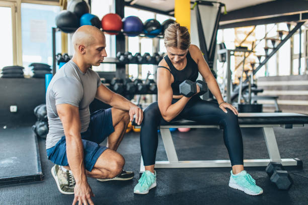 istock Woman with her personal trainer 1063910948