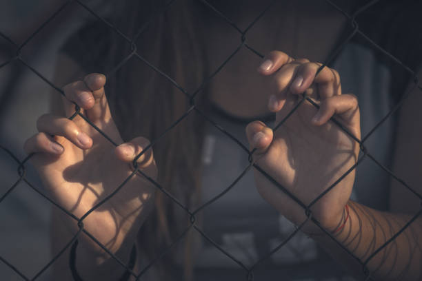 istock Girl holding the fence 1063911204