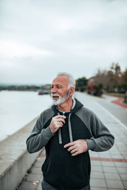 istock Vital senior male runner running by the river. 1063913354