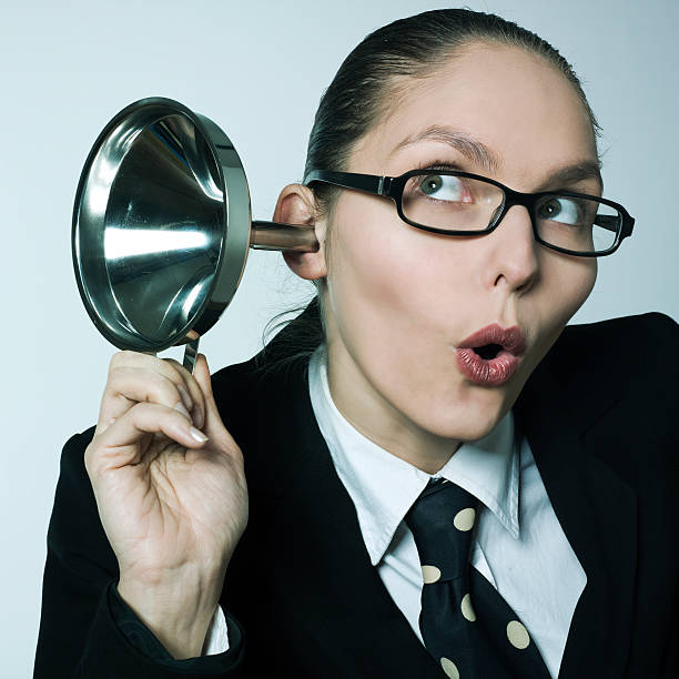gossip girl curiosity woman spying curious hearing aid studio shot portrait of a one curious young woman in a costume suit hearing aid funnel curious spying gossip ear horn photos stock pictures, royalty-free photos & images