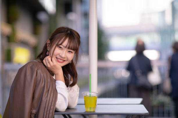 Young woman relaxing at open cafe