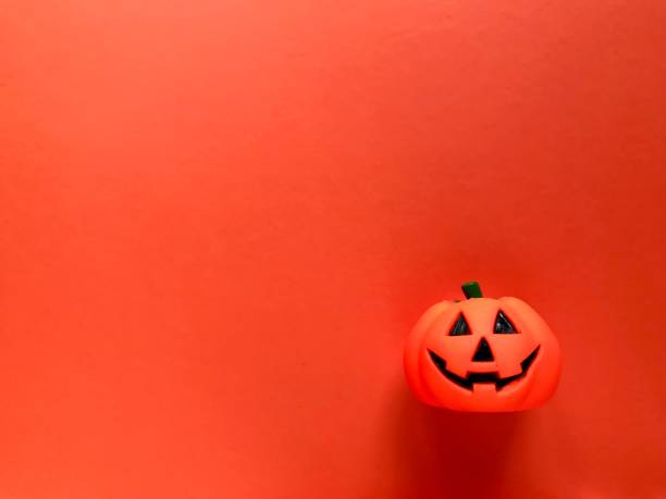 Close-Up Of Cupcakes And Pumpkin On Table During Halloween Celebration. Halloween candy bar. Jack o lantern. An adornment decorated on the day of Halloween.