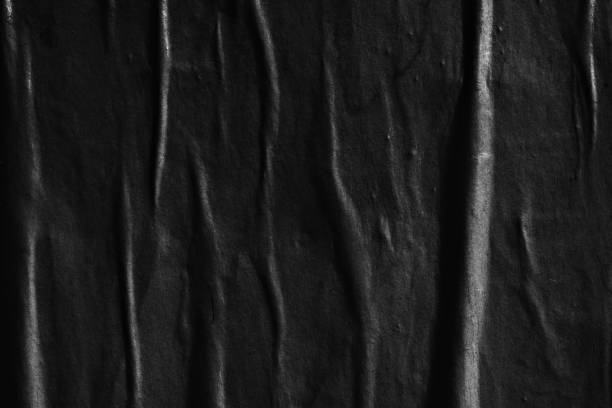 istock Dark black blank paper backgrounds creased crumpled surface old torn ripped posters grunge textures placard 1063922968
