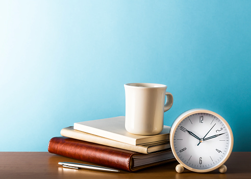 Desk clock and office supply on office desk table. With copy space. Shot with ISO64.