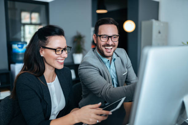 istock Two successful young business people working together. 1063924980