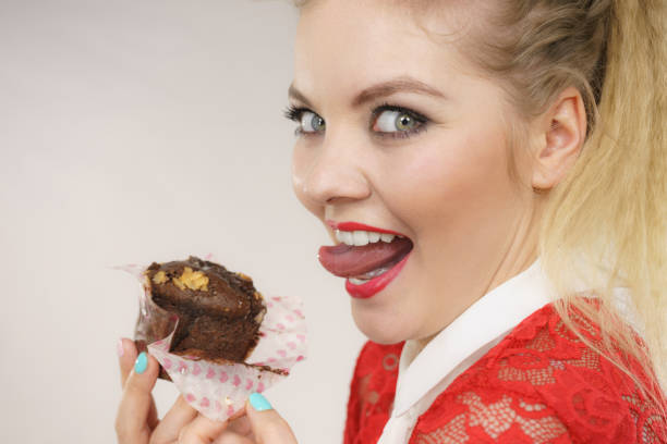 istock Attractive woman holds cake in hand 1063936370