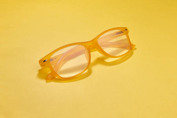 istock yellow plastic reading glasses on a yellow background 1063938448