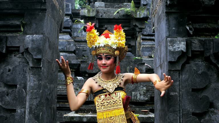 Young Balinese dancer performing Barong dance in a Hindu temple