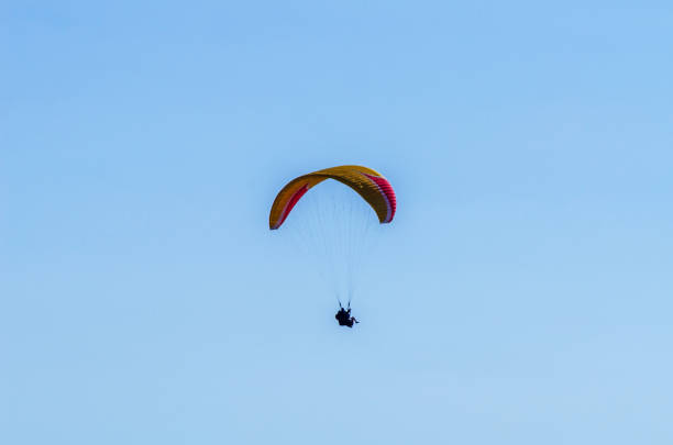 istock Paraglider flying in the sky free time spent actively wonderful experiences vacation 1063942402