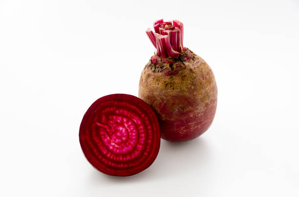 istock Isolated beet. Whole red beetroot and a half isolated on white background. 1063944412
