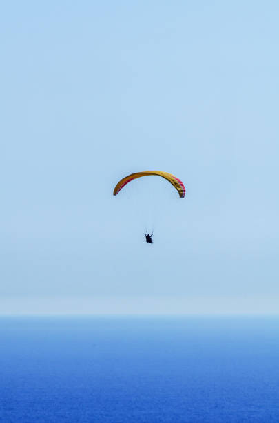 istock Paraglider flying in the sky free time spent actively wonderful experiences vacation 1063944448