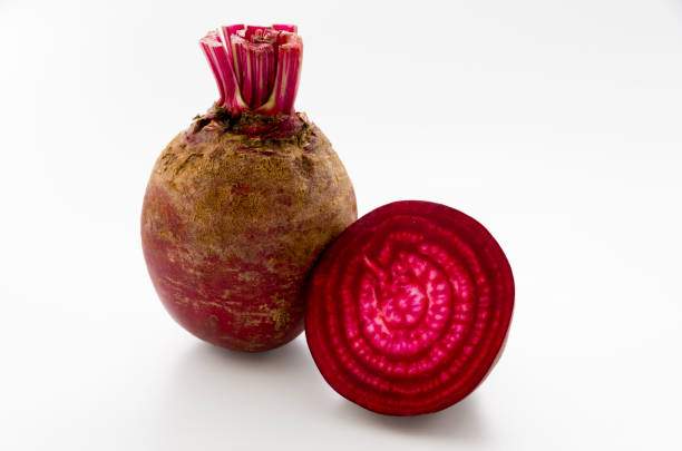 istock Isolated beet. Whole red beetroot and a half isolated on white background. 1063944548