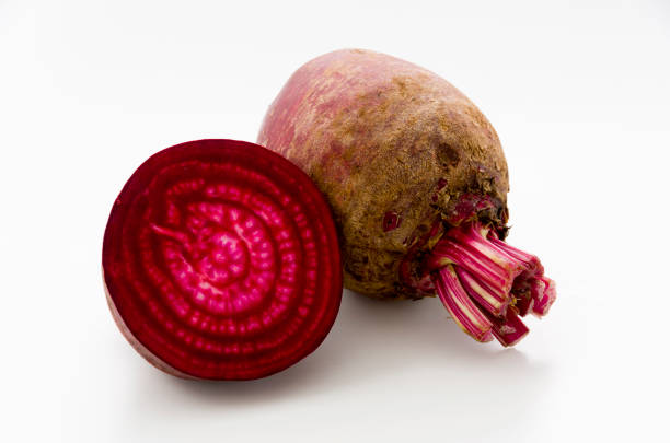 istock Isolated beet. Whole red beetroot and a half isolated on white background. 1063944552