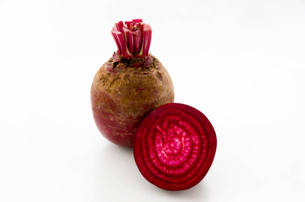 istock Isolated beet. Whole red beetroot and a half isolated on white background. 1063944578