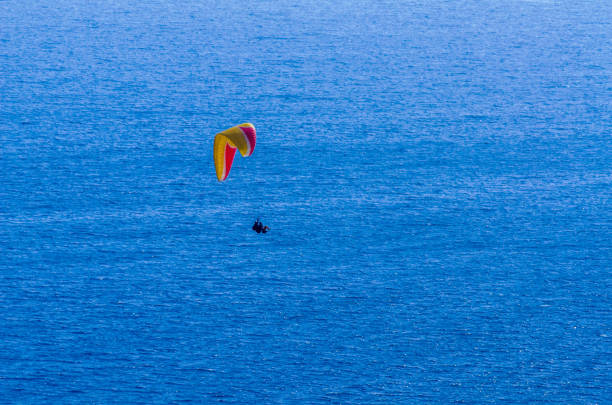 istock Paraglider flying in the sky free time spent actively wonderful experiences vacation 1063944880