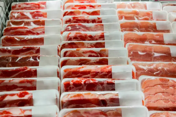 Closeup of fresh raw meat on the boxes in the supermarket