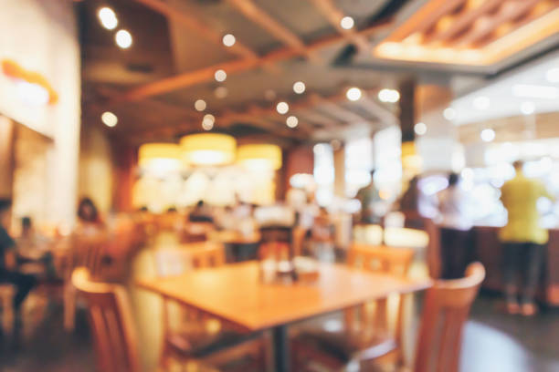 istock Restaurant interior with customer and wood table blur abstract background with bokeh light 1063947322