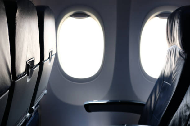 istock airplane window inside cabin. opening aircraft porthole 1063947640