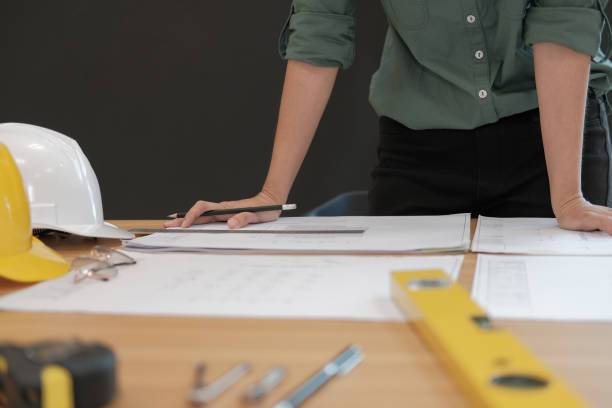 istock architect engineer working on house blueprint of real estate project at workplace. building construction concept 1063947774