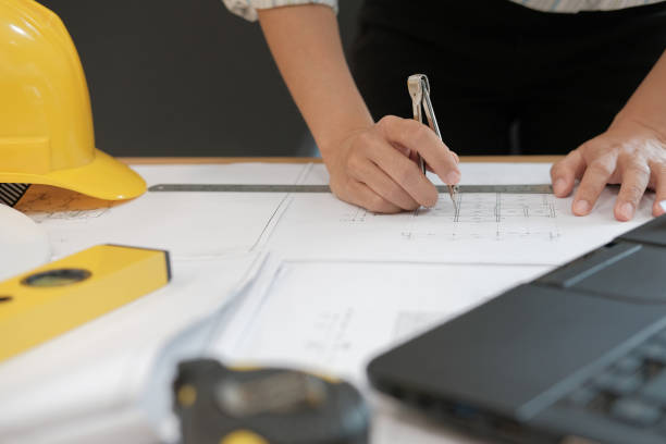 istock architect engineer working on house blueprint of real estate project at workplace. building construction concept 1063947836