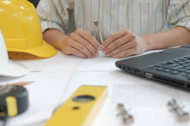 istock architect engineer working on house blueprint of real estate project at workplace. building construction concept 1063947854