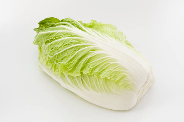 istock Napa cabbage or Chinese cabbage half, isolated white background 1063947918
